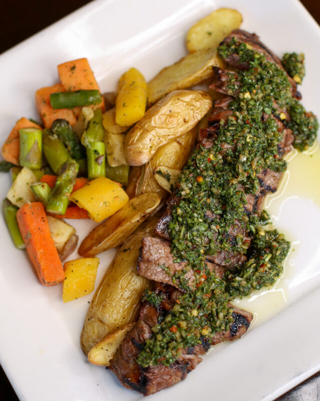 Steak, potato wedges and mixed vegetables on a plate